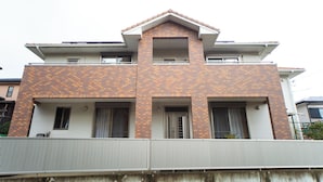A two-story building with a brick facade and a flat roof. - Awaji Central in Kuruma (Awaji)