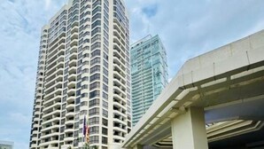 A high-rise building with multiple balconies, a modern architectural style, and a clear sky in the background. - Luxury Sea View 3 Bedroom AC Apartment 5 star hotel access and all amenities (Colombo)