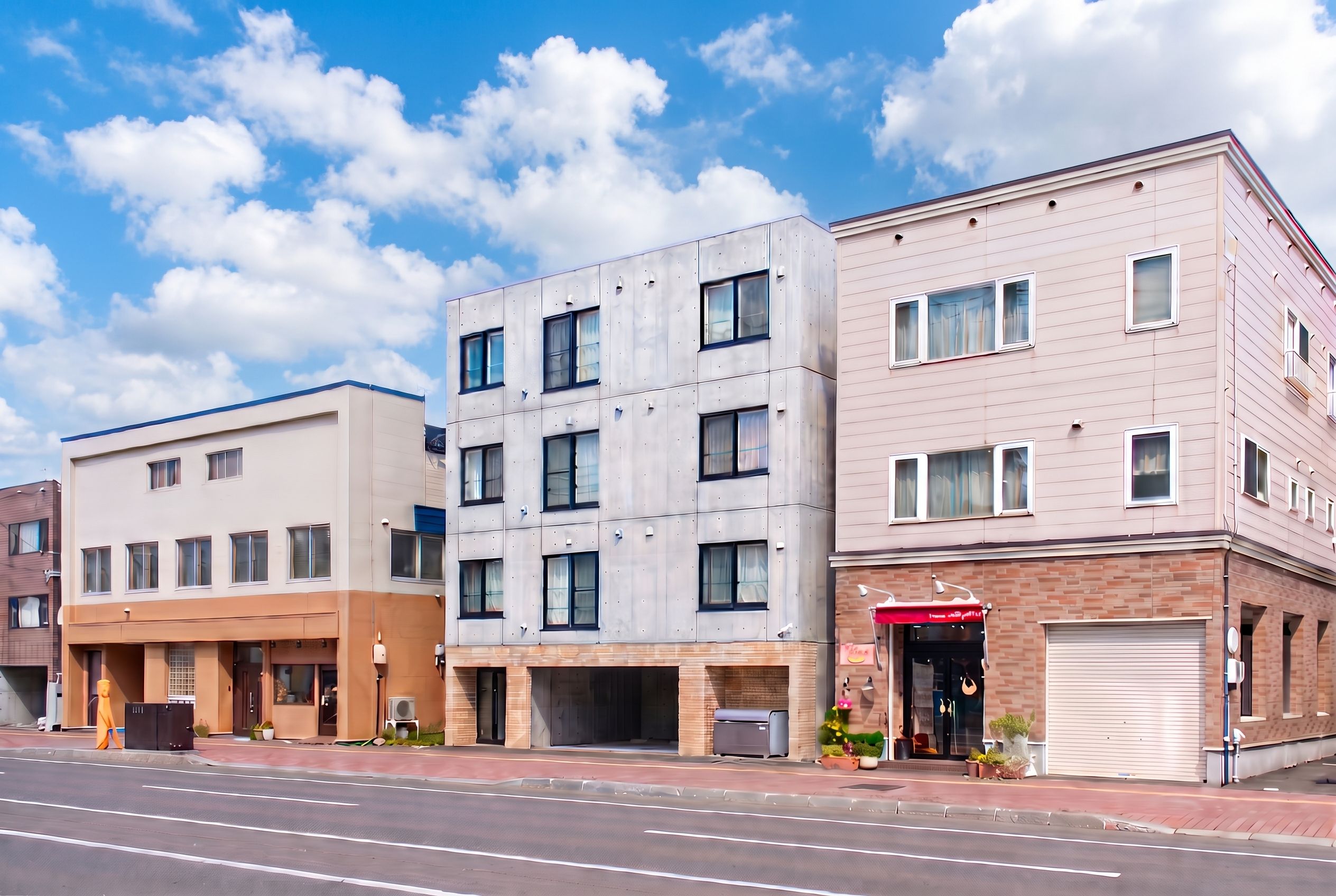A row of modern multi-story buildings with a flat roof, large windows, and a clean facade.
