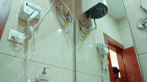 A bathroom with a white sink, a mirror, a hairdryer, and a towel rack.
