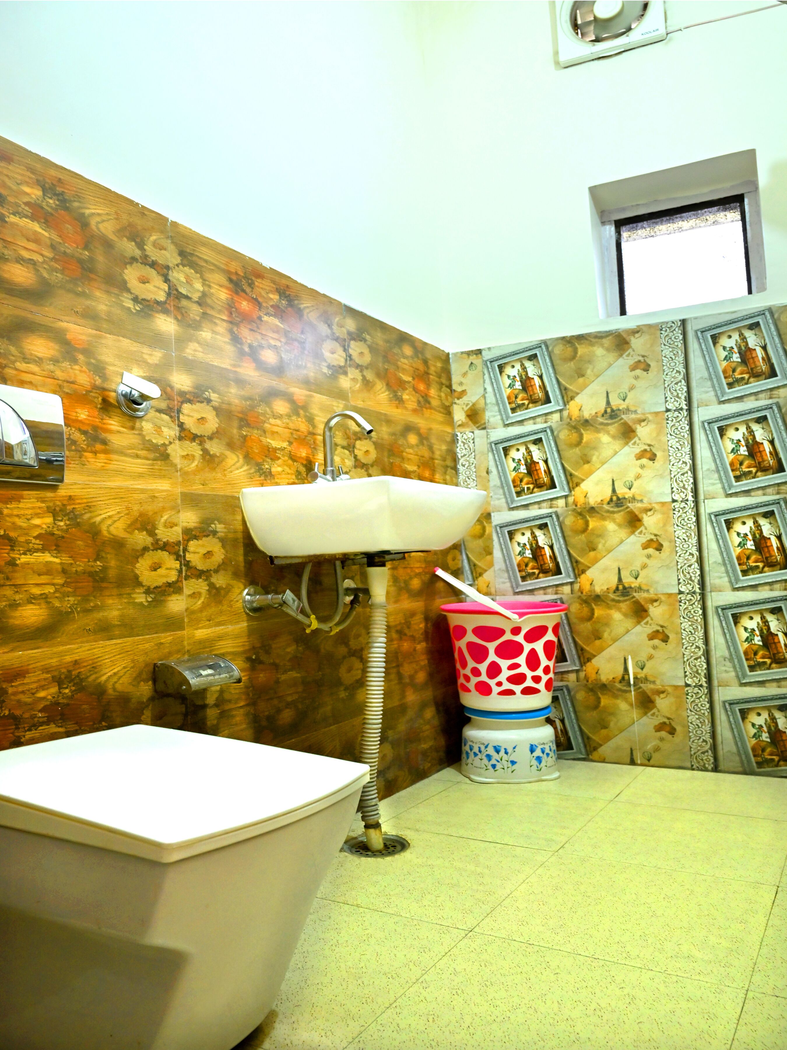 A bathroom with a white sink, a bathtub, and a shower. The walls are decorated with floral patterns and framed pictures.