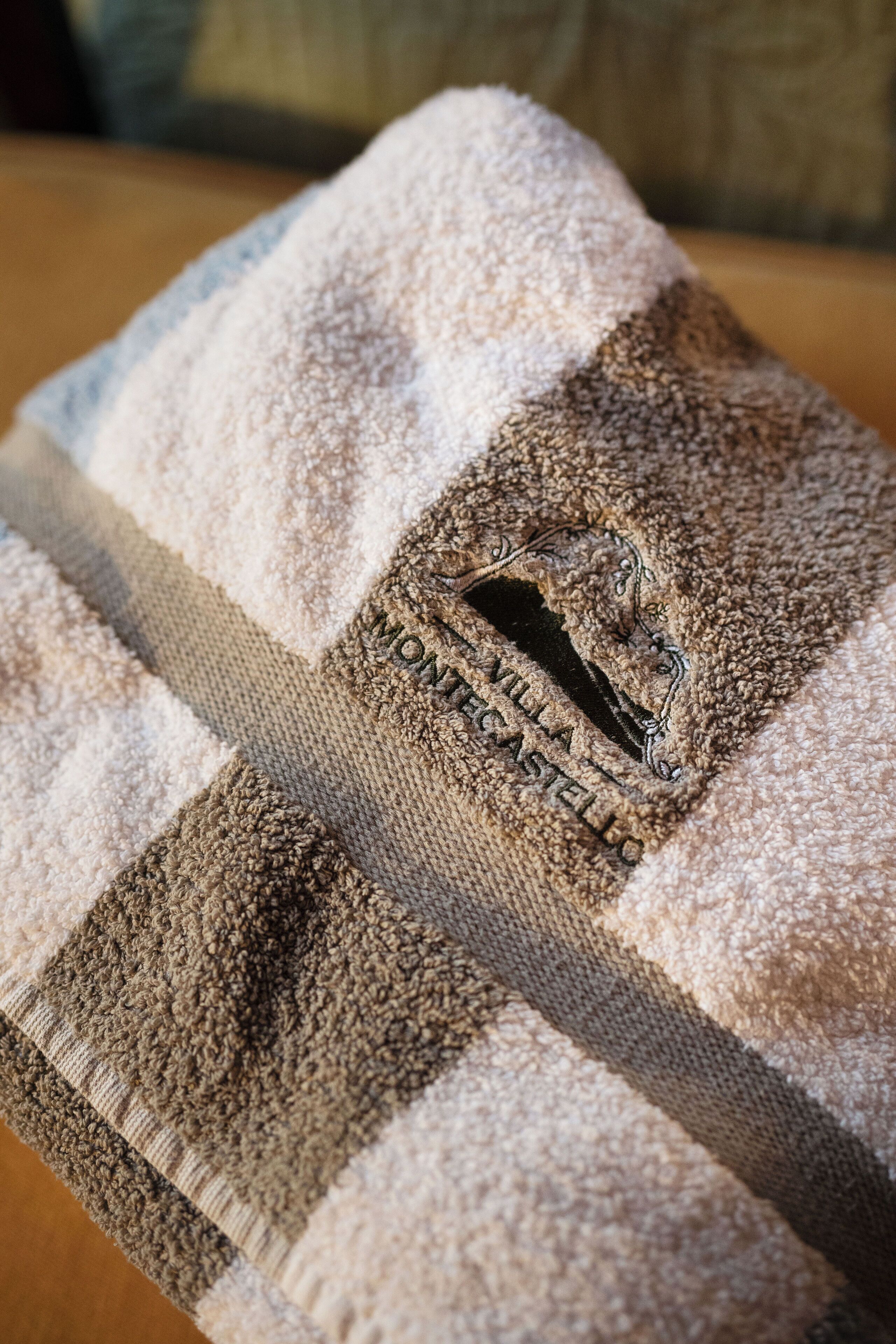 A close-up of a checkered towel with a monogrammed logo.