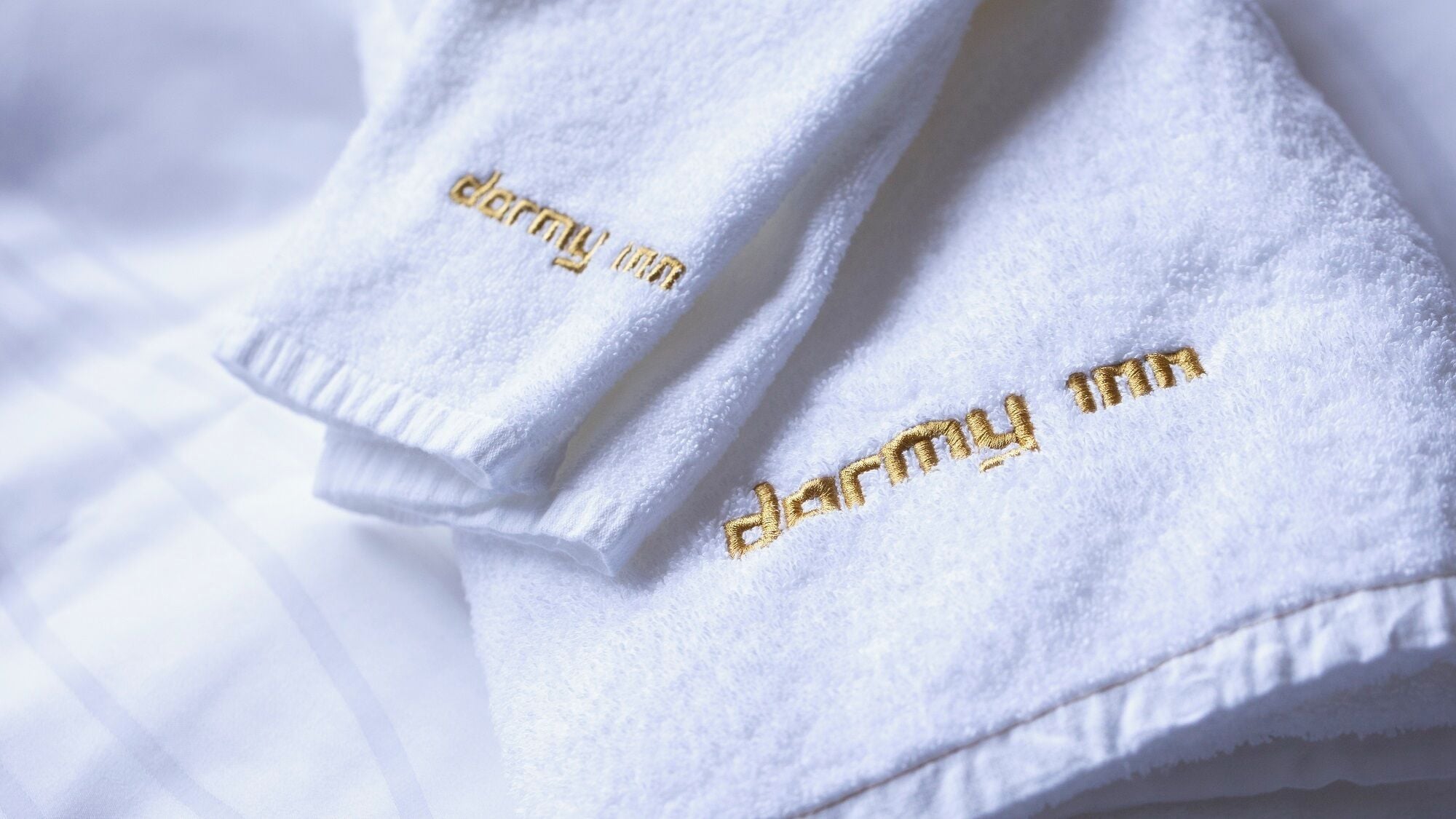 A white towel with embroidered text.