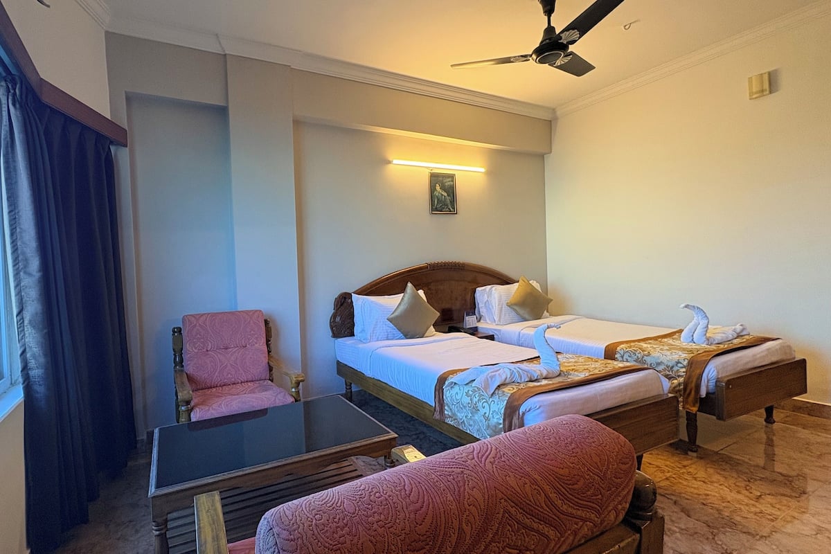 Premium bedding, desk, laptop workspace, blackout drapes