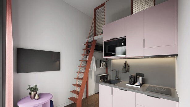 Una cocina moderna con microondas, cafetera y un pequeño comedor con mesa y sillas.