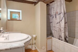 A bathroom with a sink, toilet, and shower curtain. - Small House on 5 Hectares with Pool, Sauna, Gym, Horses, Donkey (Osse-en-Aspe)