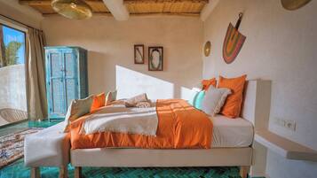 A bedroom with a bed, a wardrobe, and a window.