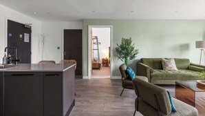 A modern apartment with a kitchen, living area, and a doorway leading to a bedroom. - York Retreat • Shambles • Free Parking • Gym Access (York)