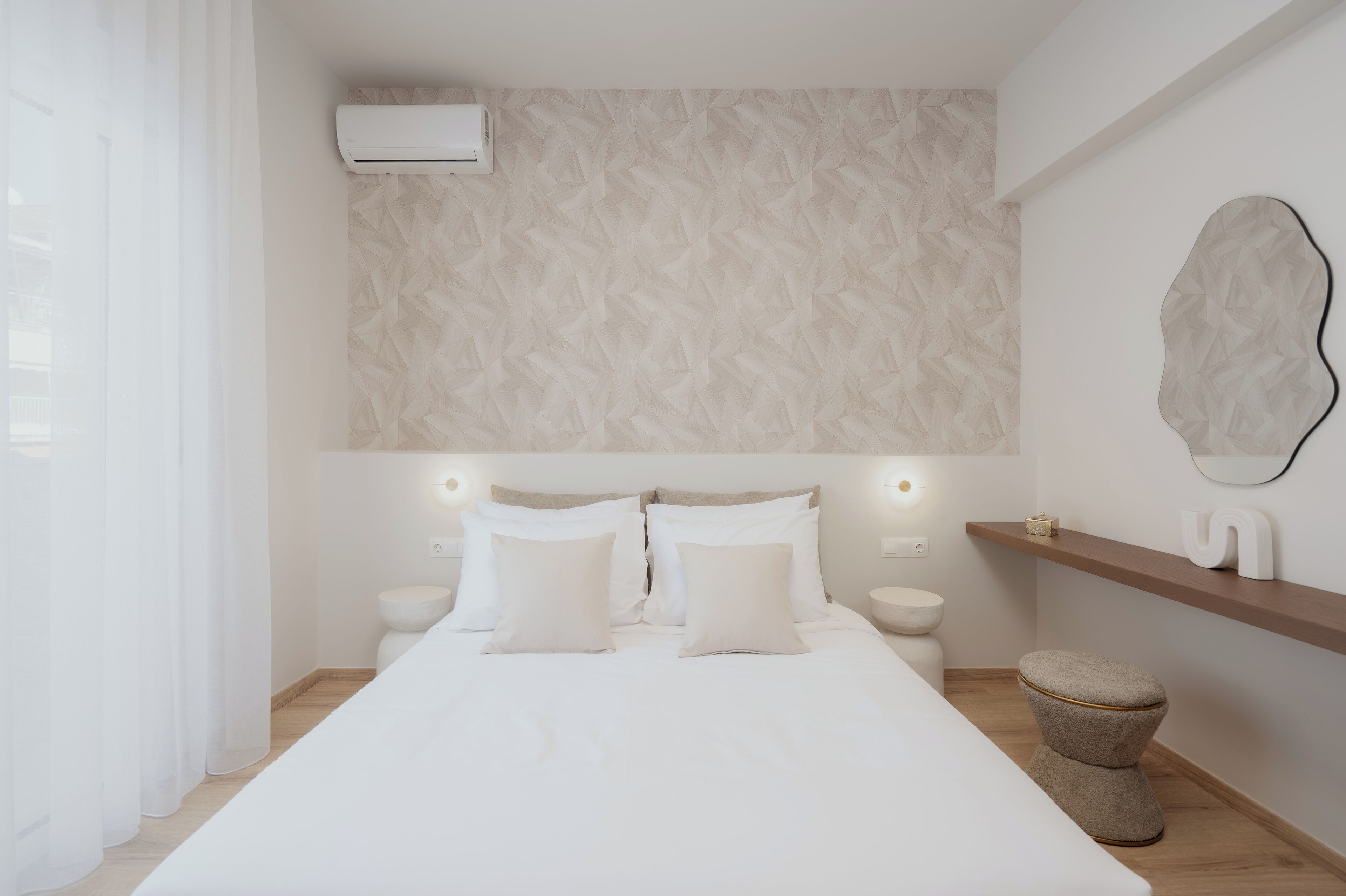 A modern bedroom with a bed, bedside tables, a wall-mounted air conditioner, and a wooden shelf.