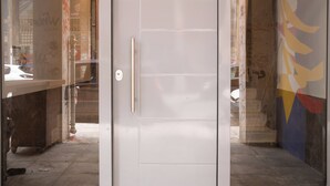 A white door with a handle, a glass panel, and a metal frame. - Luxury & Spacious Penthouse in Athens with Terrace  (Athens)
