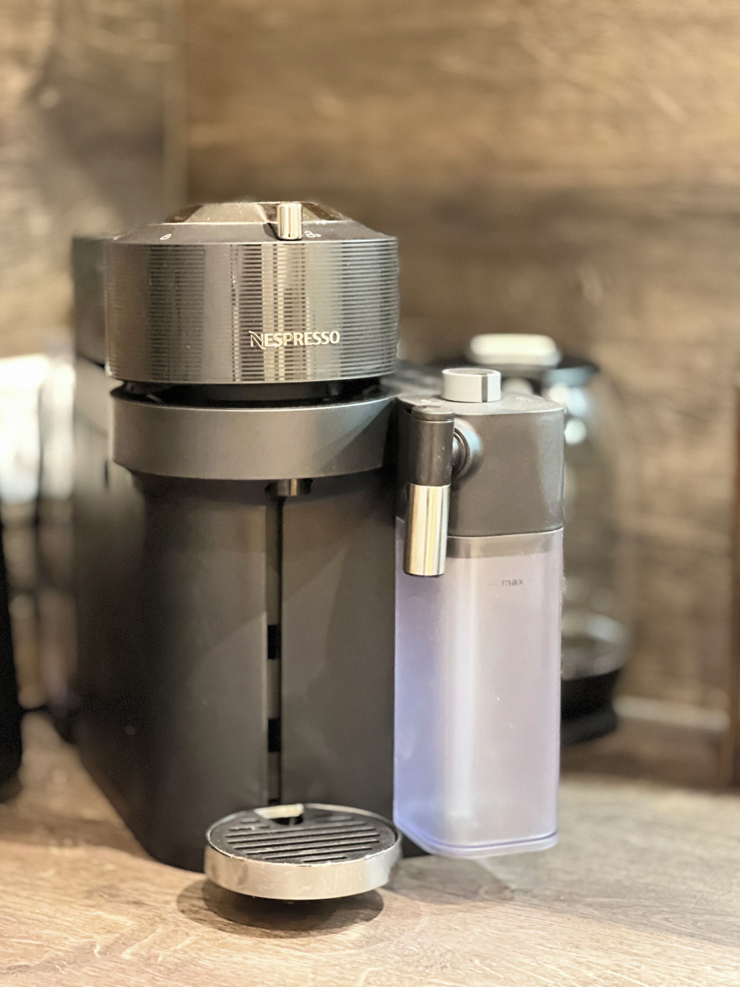 A Nespresso coffee machine and a water bottle on a countertop.