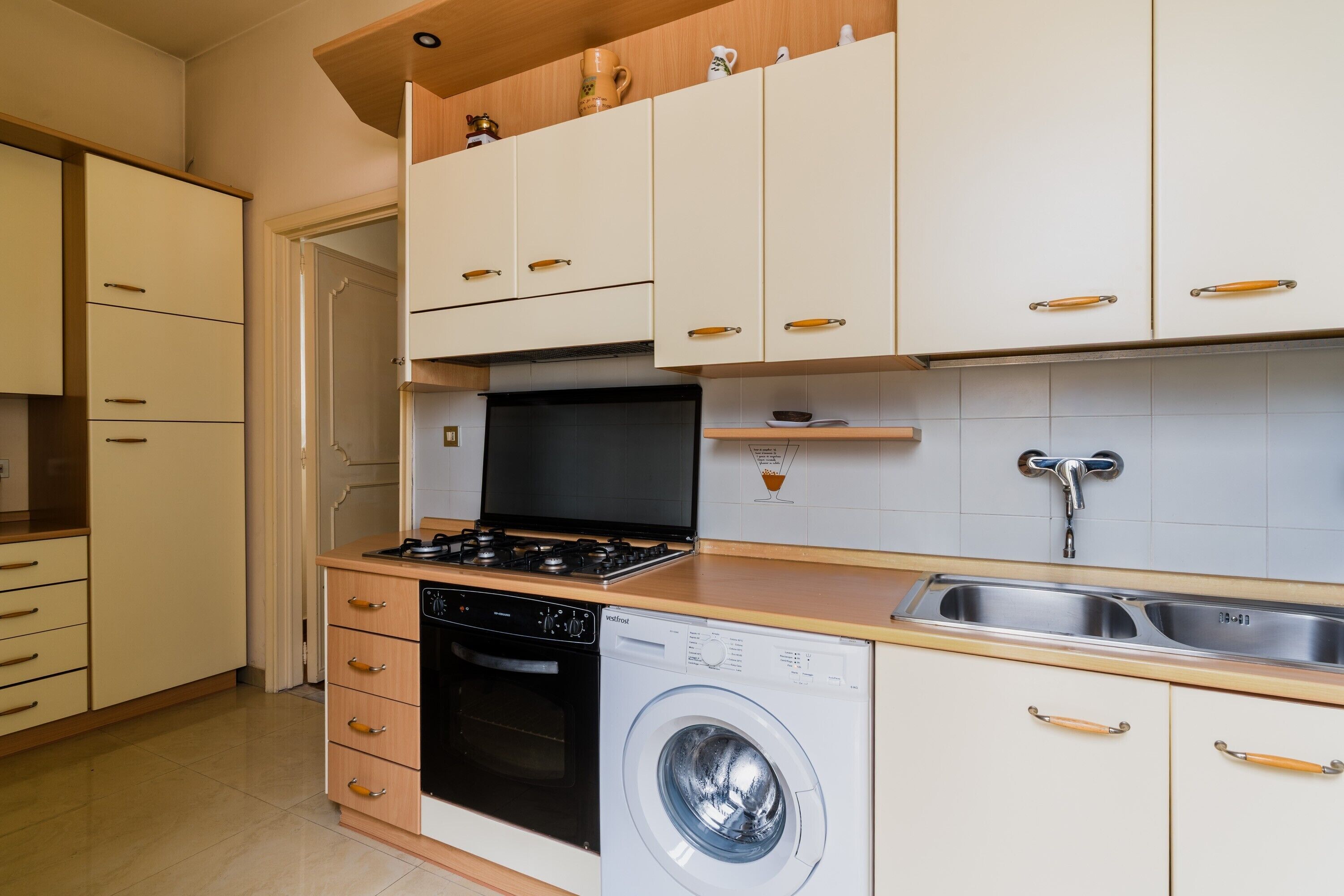 A kitchen with a stove, oven, dishwasher, and sink.
