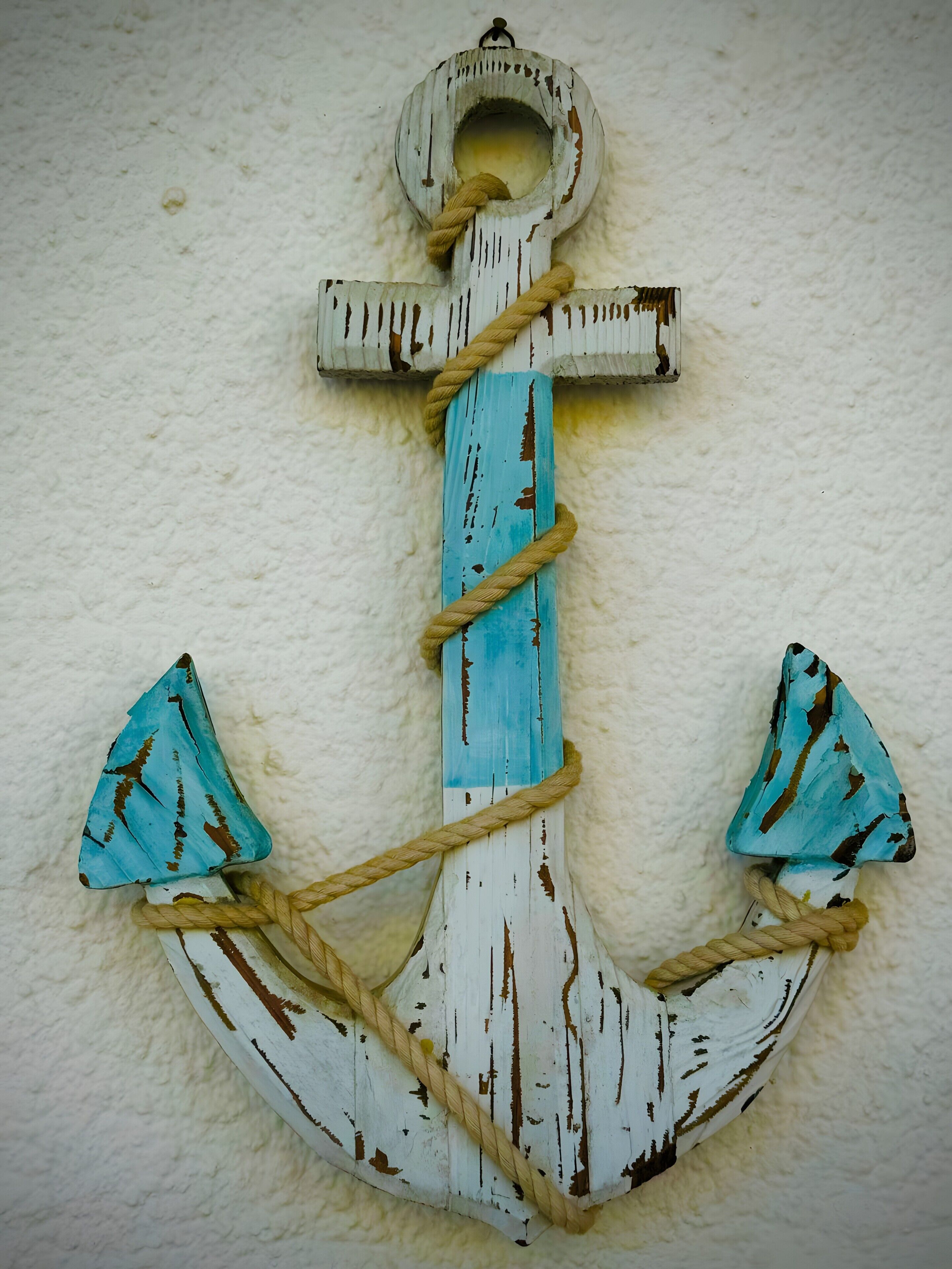 A rustic anchor decoration with a rope.