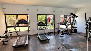 A gym with treadmills, dumbbells, and weight machines. - Upland Serviced Apartments (Lusaka)