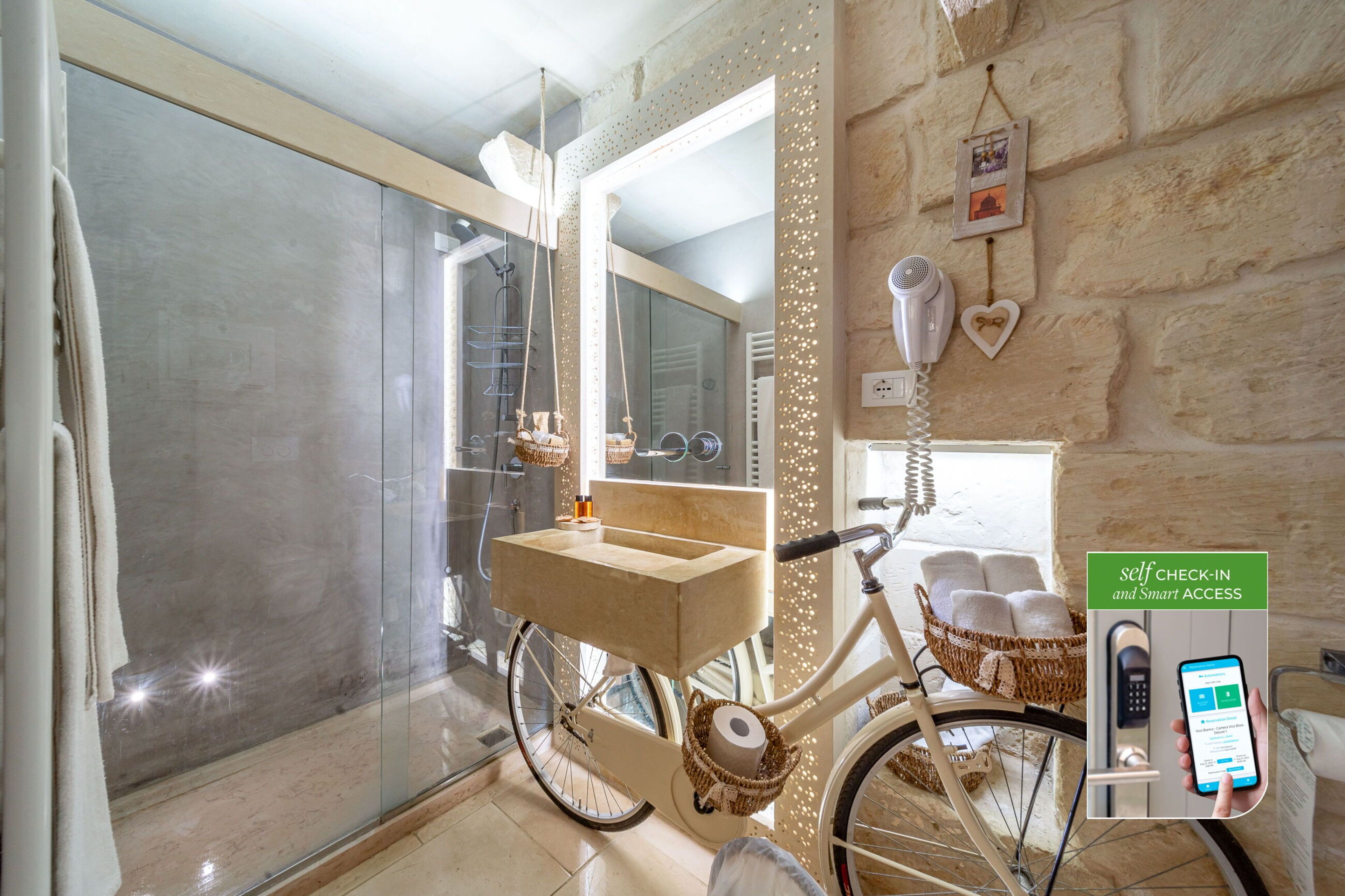 A modern bathroom with a glass shower enclosure, a vanity with a towel rack, and a bicycle with a basket.