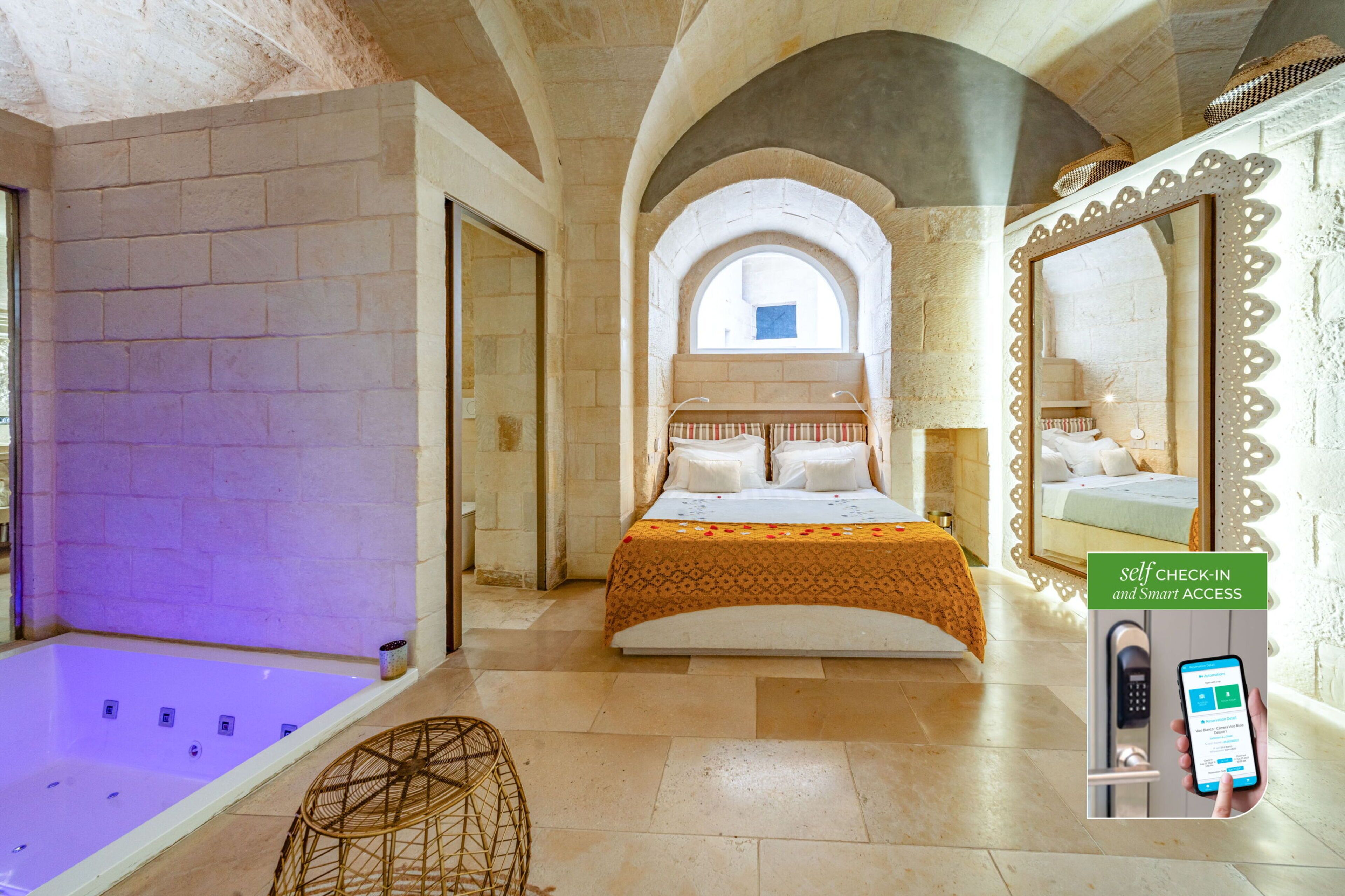A hotel room with a bed, a bathtub, and a self-check-in kiosk.