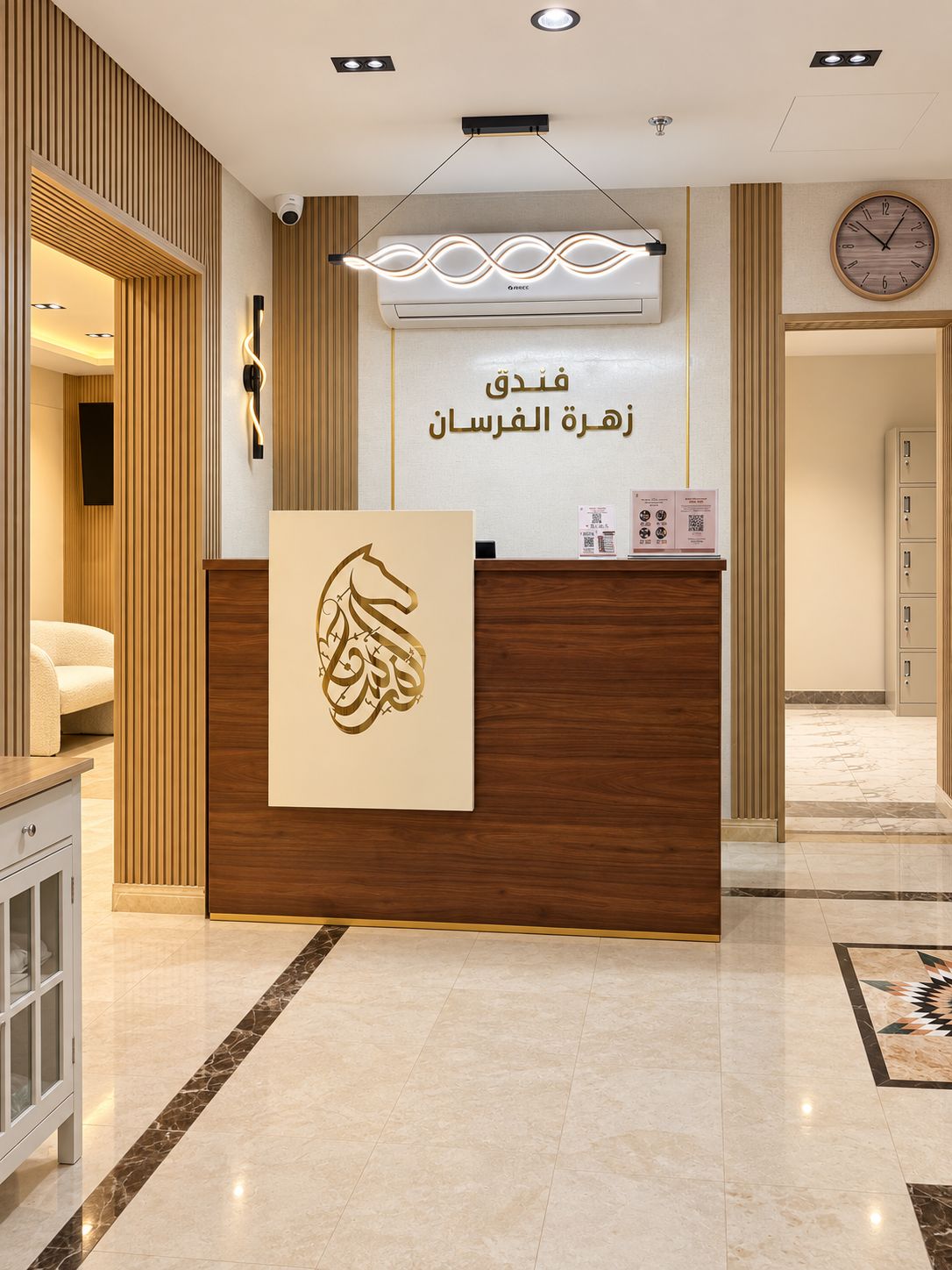 A hotel reception desk with a modern design, a clock, and a security camera.