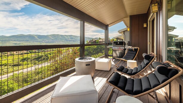 A balcony with outdoor furniture, a grill, and a view of the landscape. - Mayflower Vista - Deer Valley East Basecamp for All Seassons w/ Views, Private Hot Tub (Heber City)
