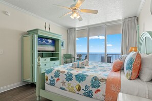 A bedroom with a bed, a television, a dresser, and a view of the ocean. - Seas the Day! Your Perfect 2BR Beachfront Escape! Sleeps 8! (Panama City Beach)