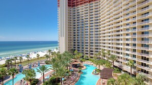 A high-rise hotel with a pool area, beach access, and a view of the ocean. - Looking for a Shore Thing? Here it is! 2BR 2.5ba Sleeps 8! Beachfront! (Panama City Beach)