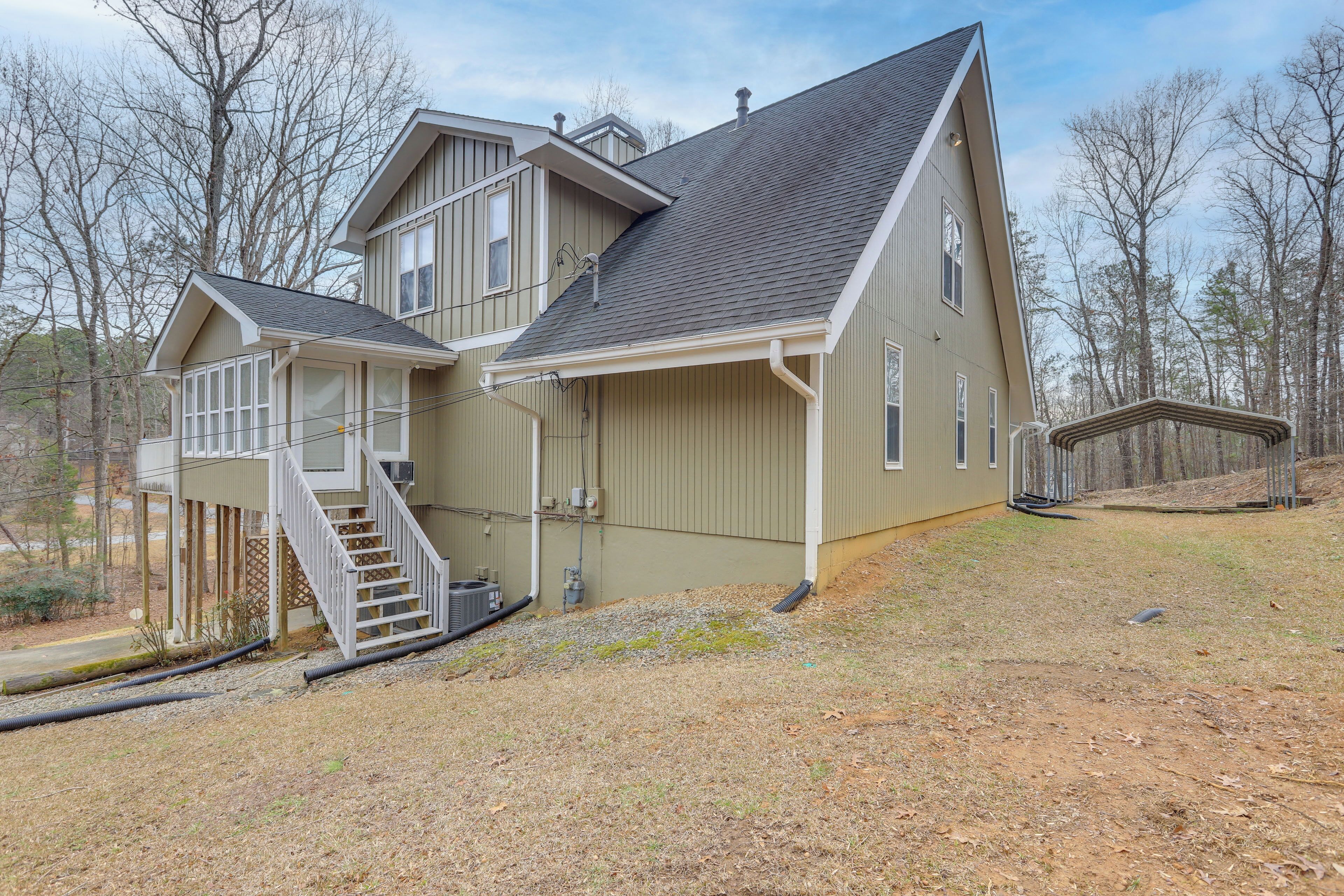 A two-story house with a covered porch and a staircase leading to the upper level.