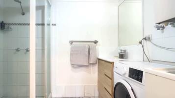 Shower, hair dryer, towels, shampoo