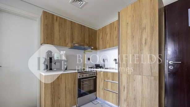 Eine moderne Küche mit Holzschränken und einem eingebauten Backofen.