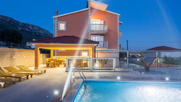 A two-story building with a swimming pool, outdoor seating, and a covered patio area. - Villa Ana With Outdoor Pool, Sauna and Hot-tub (Kastela)