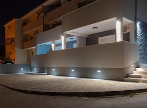 A modern building with multiple balconies and a paved entrance area. - Vacation Home Pasalic (Kastela)