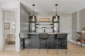 A modern kitchen with a bar area, featuring a sign that reads 'ALICE B GREENTOWN NY'. - Spacious Ski Getaway Hot Tub 5 Bedroom 5 Home (Heber City)