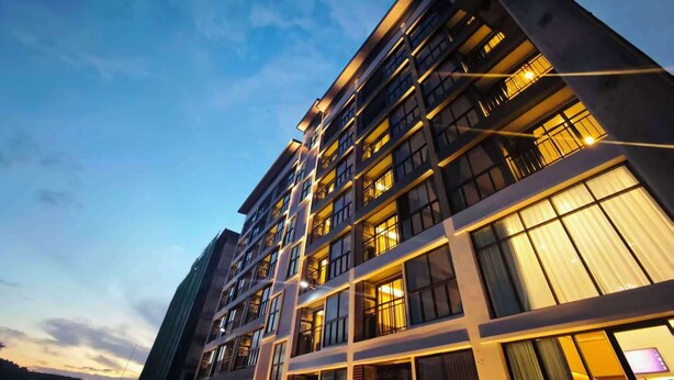 A multi-story hotel with a modern architectural design, featuring balconies and large windows. - ATOUR Rayong Hotel (Pluak Daeng)