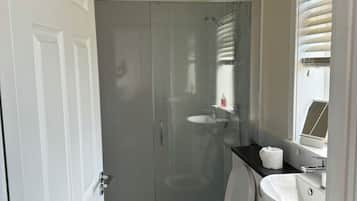 Shower, hair dryer, towels, soap