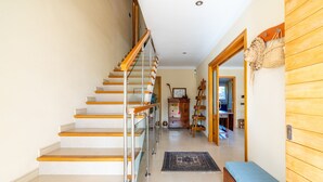 A staircase with wooden steps and glass railings, leading to a room with a bench and a wooden wall. - Aimima - with private swimming pool (Palma)