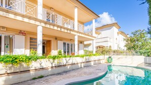 A hotel with a pool, outdoor seating, and a balcony with railing. - Aimima - with private swimming pool (Palma)
