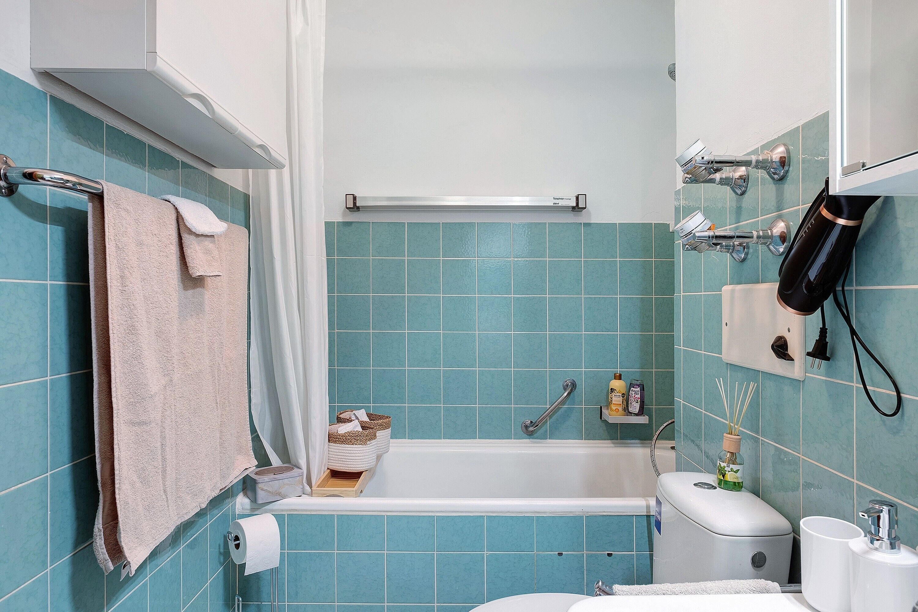 A bathroom with a bathtub, a toilet, and a sink.
