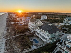 A coastal residential area with multiple houses, a swimming pool, and a beach. - La Grande Dame - Oceanfront 8BR, Private Pool, Elevator, Game Room + Theater (North Topsail Beach)