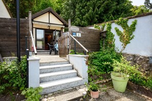 A wooden fence, a set of stone steps leading to a building, and a potted plant. - La Petite Maison De Vacances with Terrace in Kaysersberg (Kaysersberg Vignoble)
