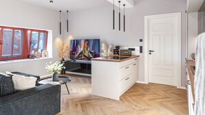 A modern kitchen with a central island, a dining area with a sofa, and a large window with a view of the outside. - The Summit Rooftop Spa Meissen – Exclusive Penthouse with Jacuzzi & Sauna (Meißen)