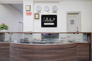 A reception desk with clocks indicating New York, Delhi, and London times, a 'Collection' sign, and a 'Visitors Not Allowed' sign. - Collection O Mysore Gokulam (Mysore)