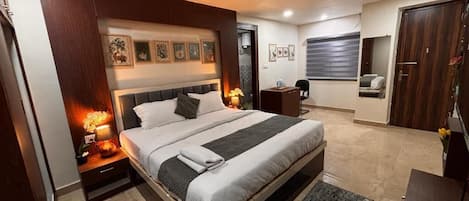 Suite estudio junior, balcón, vista a la ciudad | Escritorio, cortinas blackout y tabla de planchar con plancha