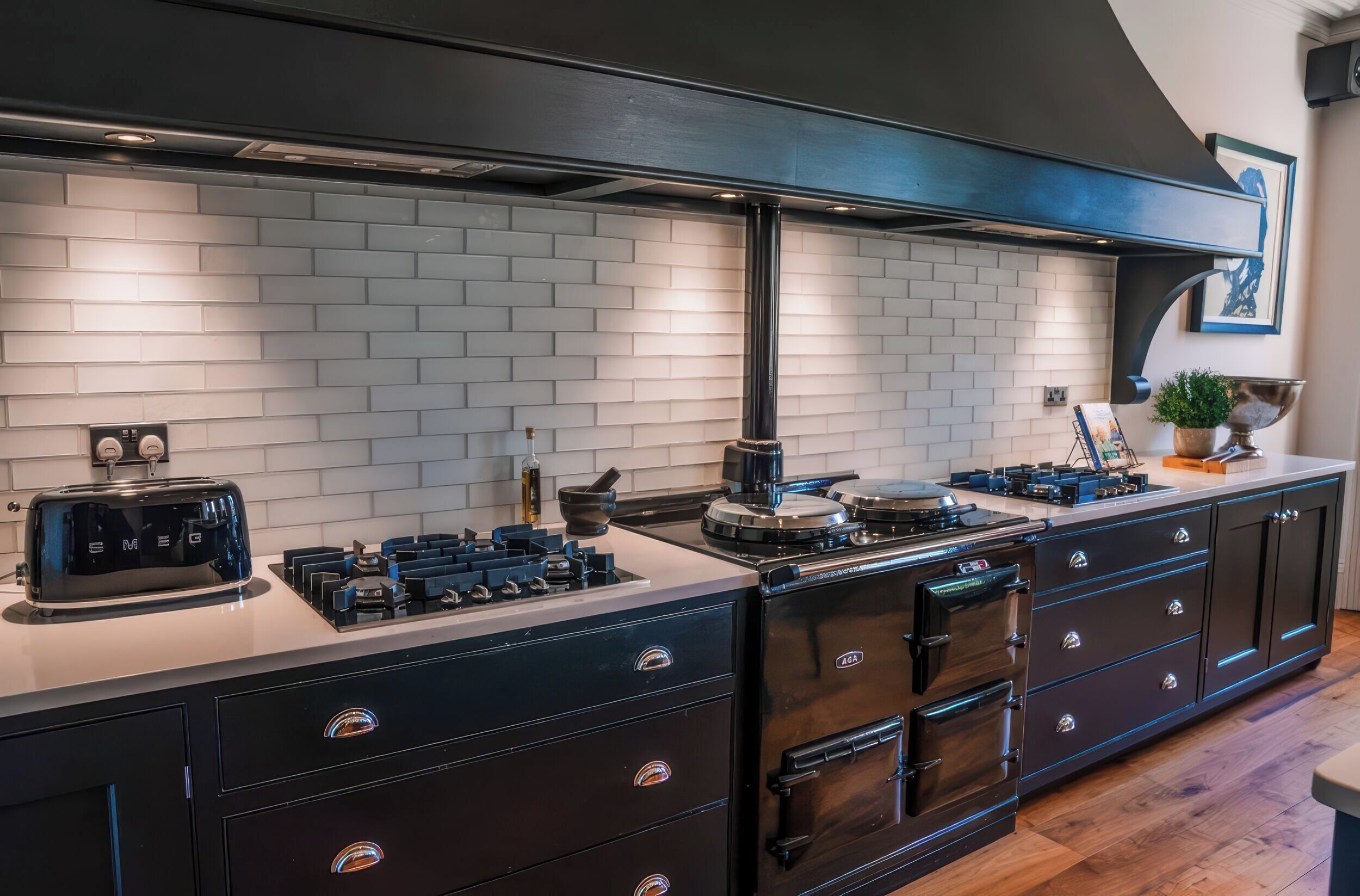 A modern kitchen with a built-in stove, toaster, and cabinets.