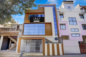 A modern building with a sign reading 'Collection.' - Classic Hotel Shree Krishna Avenu (Indore)