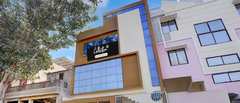 A modern building with a sign that reads 'Collection.'