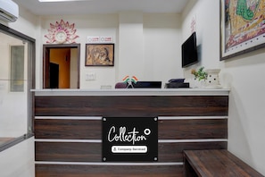A reception desk with a sign reading 'Collection' and 'Company-Serviced.' - Classic Hotel Shree Krishna Avenu (Indore)