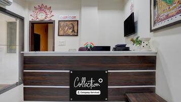 A reception desk with a sign reading 'Collection' and 'Company-Serviced.'