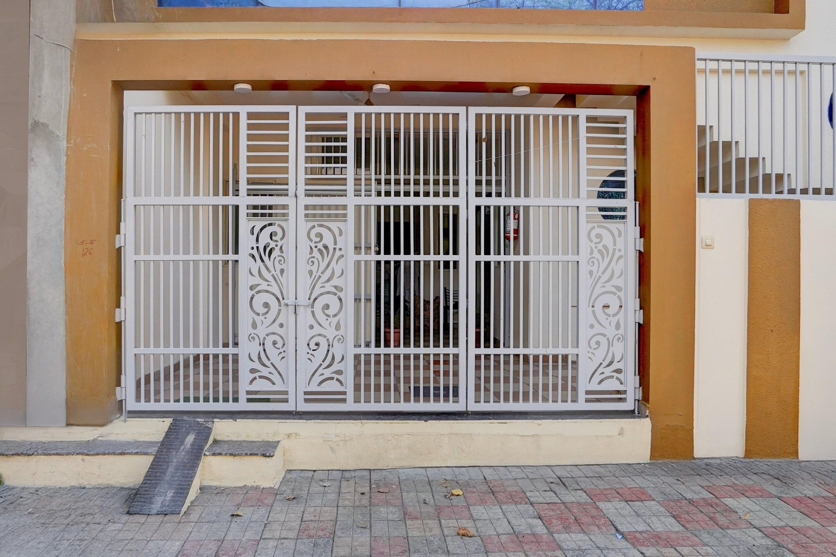 A gated entrance with a metal gate and decorative elements.