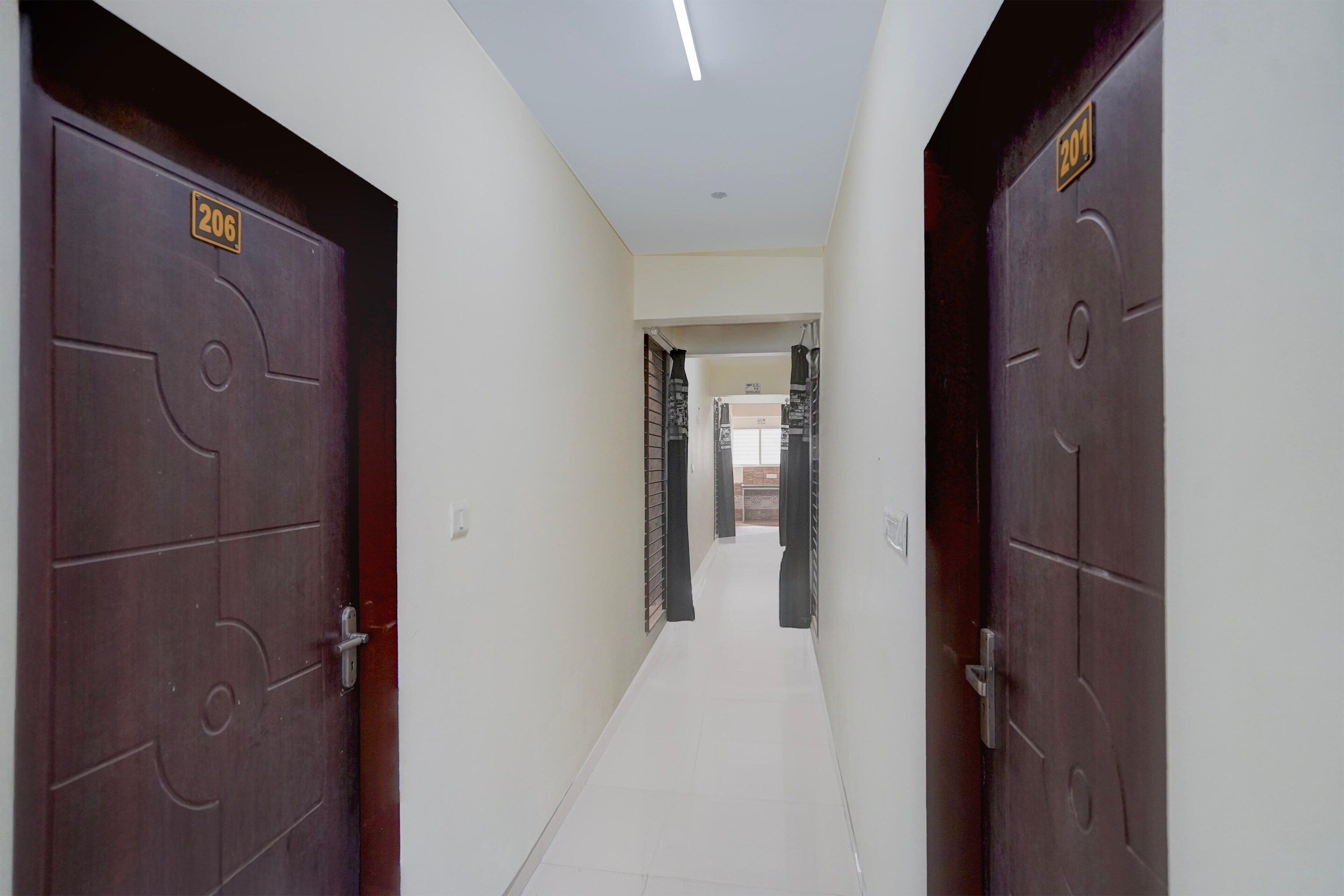 A corridor with two doors, each marked with a number.
