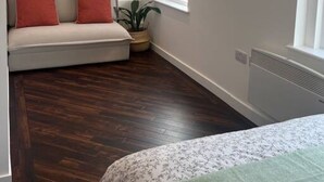 A bedroom with a bed, a window, a radiator, and a plant. - Spacious Duplex near Clapham (Greater London)