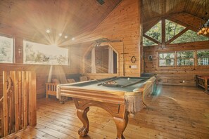 A wooden cabin with a pool table, wooden floors, and large windows. - Perfect Smokies Escape - Park View, Hot Tub & More (Sevierville)