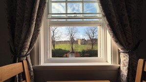 A room with a window overlooking a castle, a wooden table, and curtains. - New - Chapter House Retreat! 3 minutes walk to The Minster area! (York)